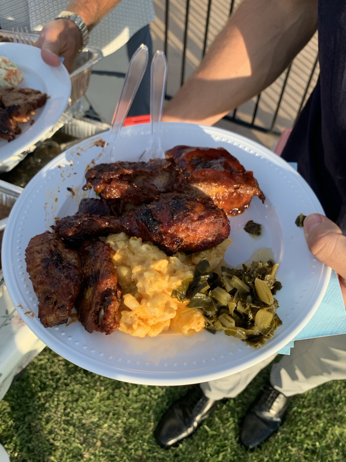 O'Side BBQ Man barbecue plate with chicken, ribs, macaroni and cheese, and greens