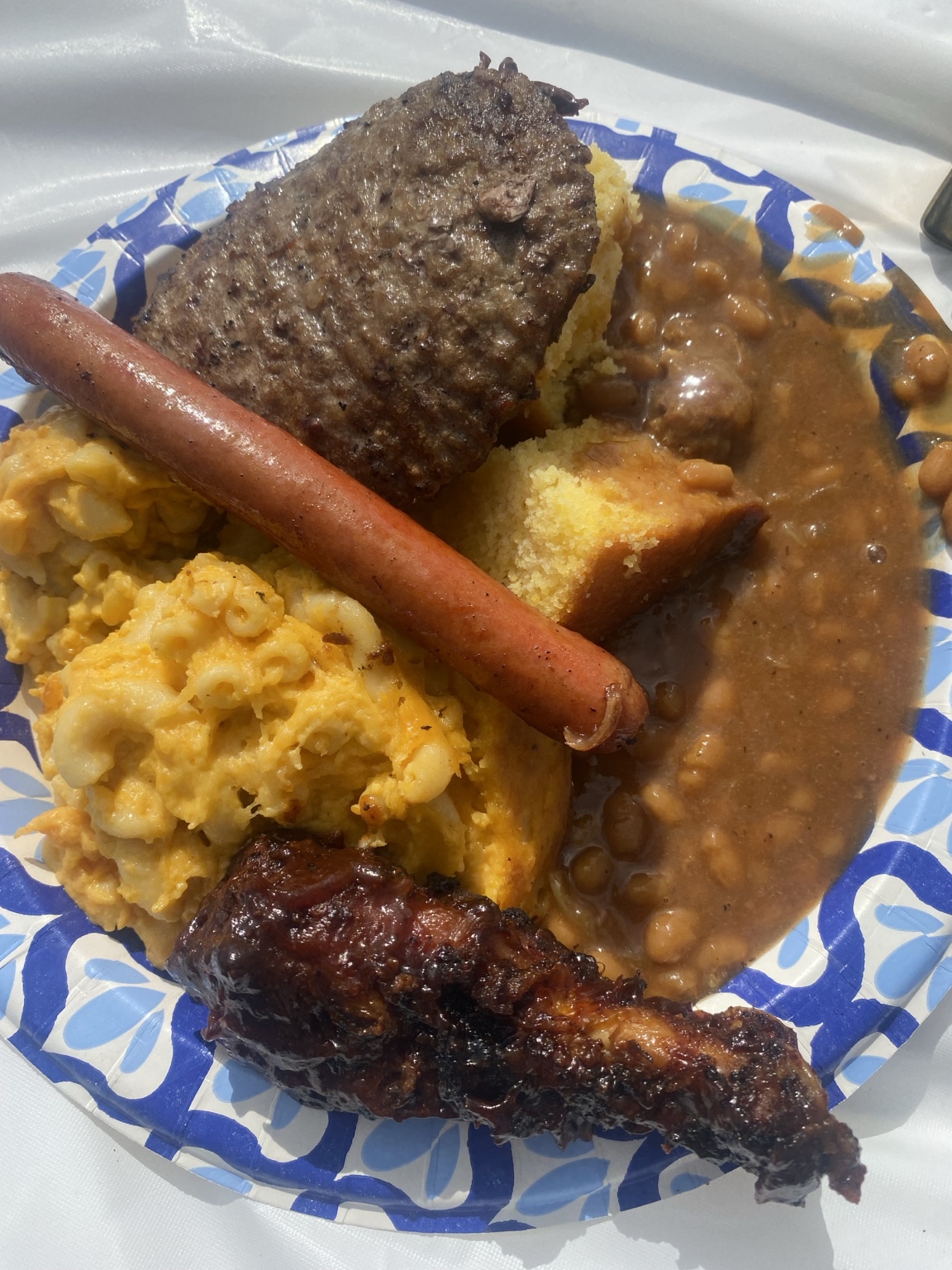 O'Side BBQ Man hot dog, hamburger steak, baked beans, macaroni and cheese, cornbread, and chicken