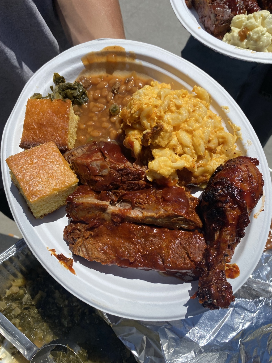 O'Side BBQ Man barbecue plate with ribs, chicken, brisket, macaroni and cheese, beans, and cornbread