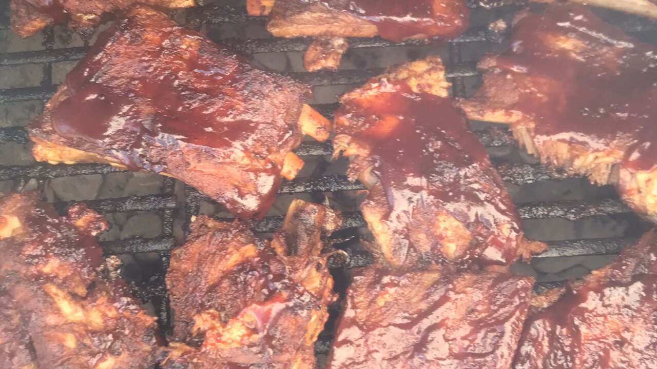O'SIDE BBQ MAN ribs cooking on the grill